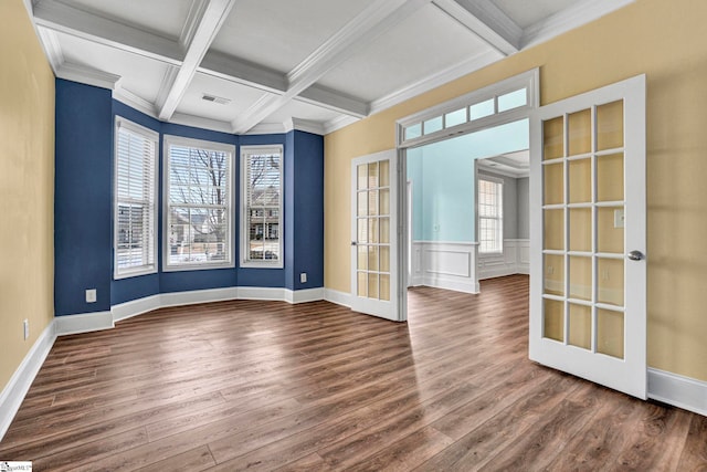 empty room featuring hardwood / wood-style flooring, coffered ceiling, beam ceiling, and french doors