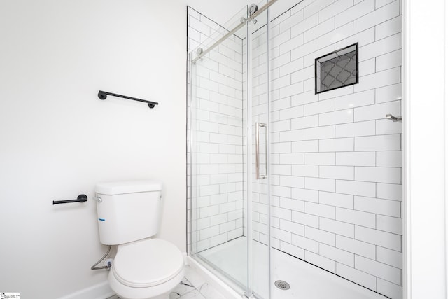 bathroom with toilet and an enclosed shower