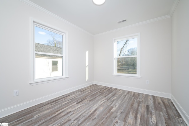 spare room featuring crown molding and wood-type flooring