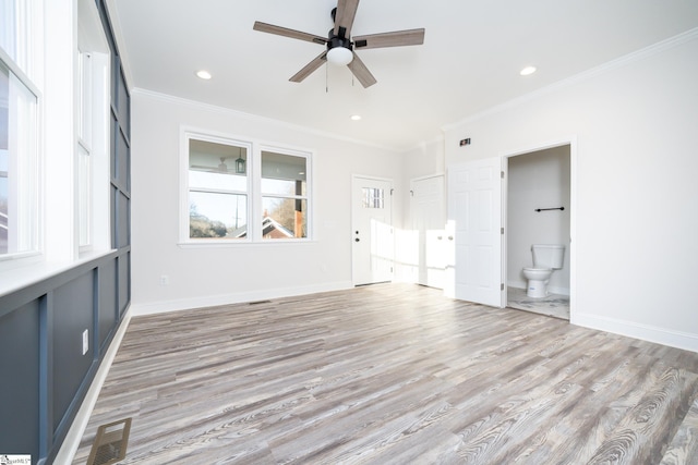 interior space with ornamental molding, ceiling fan, and light wood-type flooring