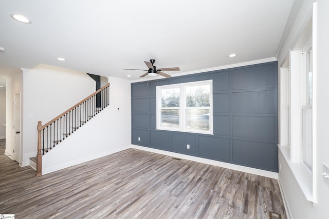 empty room with crown molding, hardwood / wood-style flooring, and ceiling fan