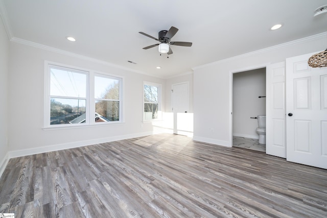 interior space with ceiling fan, ornamental molding, and wood-type flooring