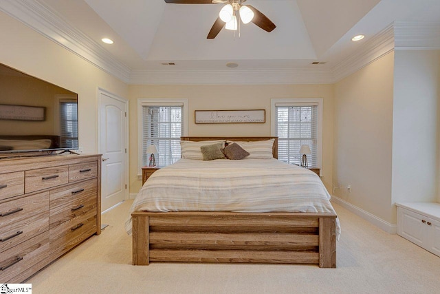 bedroom featuring multiple windows, ornamental molding, light colored carpet, and a raised ceiling