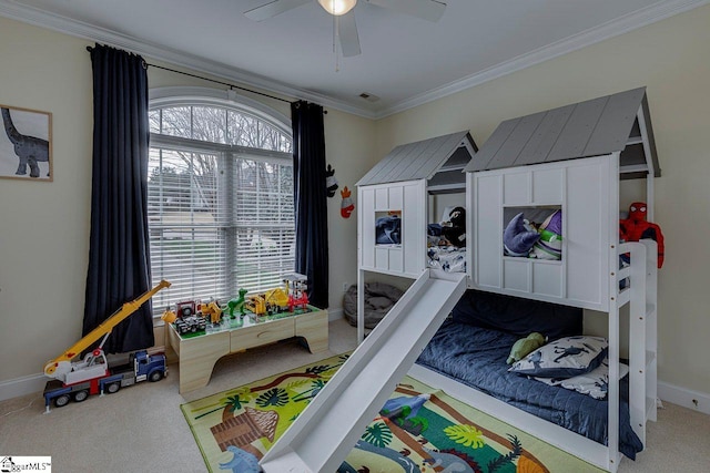 bedroom with ceiling fan, ornamental molding, and carpet