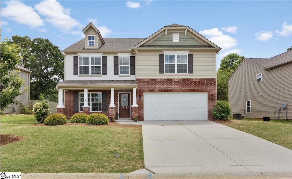 craftsman-style home with central AC unit, a garage, brick siding, driveway, and a front lawn