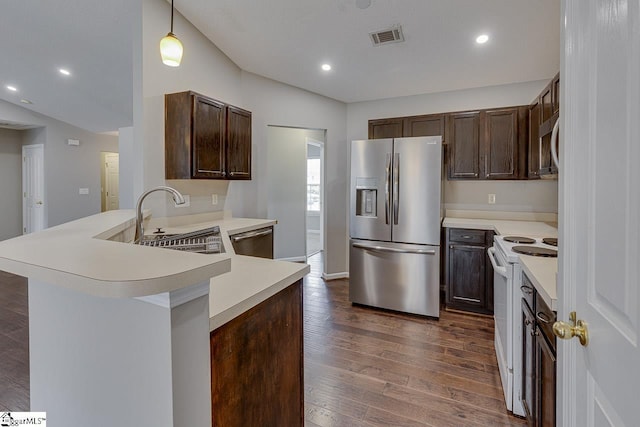 kitchen with sink, decorative light fixtures, dark hardwood / wood-style flooring, kitchen peninsula, and stainless steel appliances