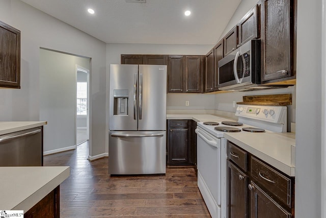 kitchen with stainless steel appliances, dark hardwood / wood-style flooring, and dark brown cabinets