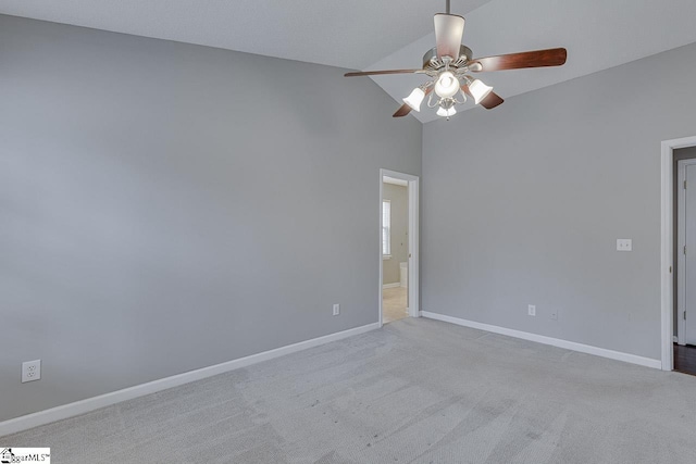 carpeted spare room featuring ceiling fan and lofted ceiling