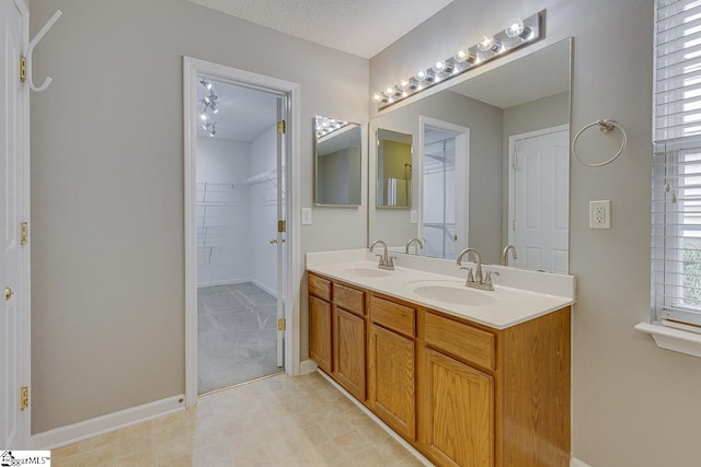 bathroom with vanity and a textured ceiling