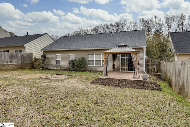 rear view of property with a yard, a gazebo, and a patio