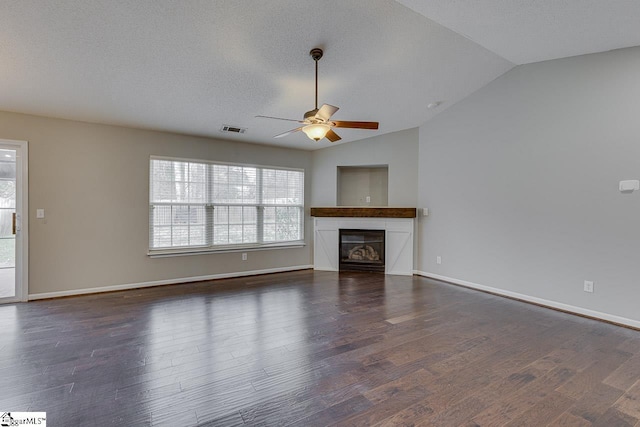 unfurnished living room featuring ceiling fan, dark hardwood / wood-style flooring, and vaulted ceiling