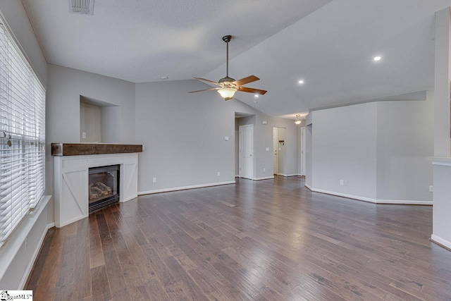 unfurnished living room with ceiling fan, dark hardwood / wood-style floors, and vaulted ceiling