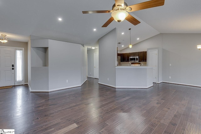 unfurnished living room with dark wood-type flooring, ceiling fan, and lofted ceiling