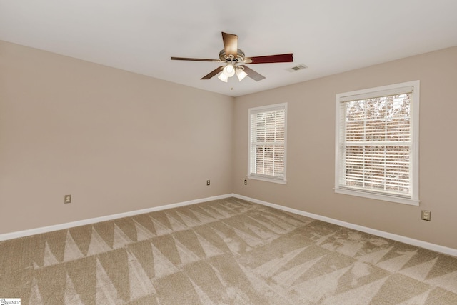 empty room featuring carpet and ceiling fan