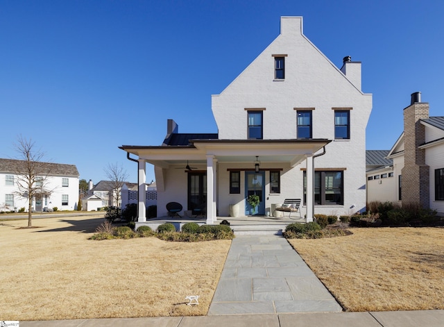 view of front of house featuring a front yard and covered porch