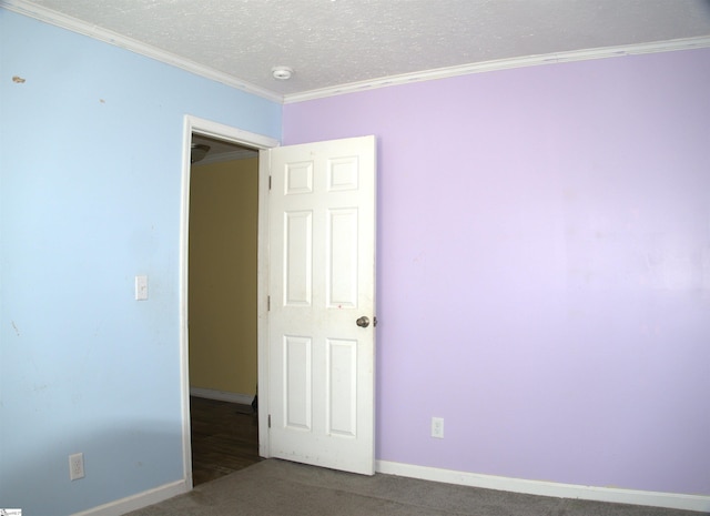 carpeted empty room featuring crown molding and a textured ceiling