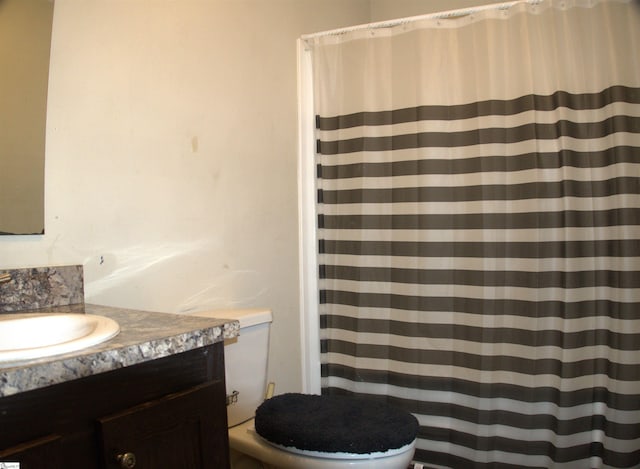 bathroom featuring vanity and toilet