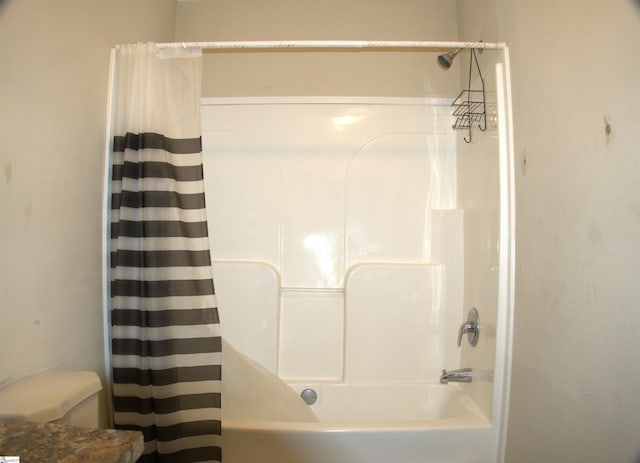 bathroom with shower / bathtub combination with curtain and toilet