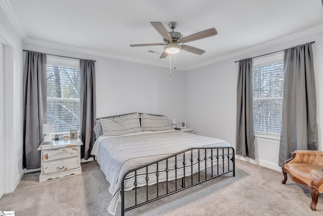 carpeted bedroom featuring ceiling fan and ornamental molding