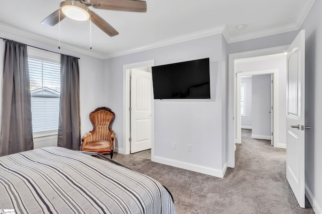 carpeted bedroom featuring ornamental molding and ceiling fan