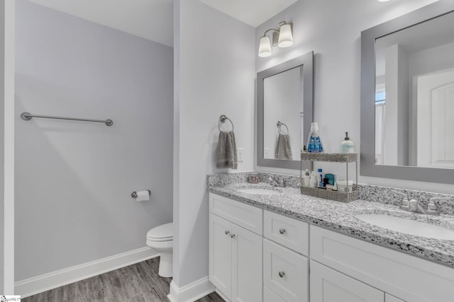 bathroom with vanity, hardwood / wood-style floors, and toilet