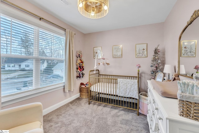 carpeted bedroom with a nursery area