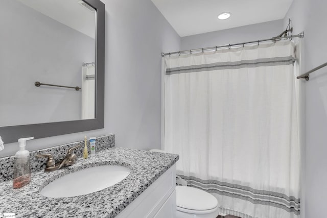 bathroom featuring vanity and toilet