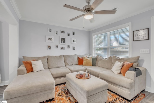 living room featuring crown molding, wood-type flooring, and ceiling fan