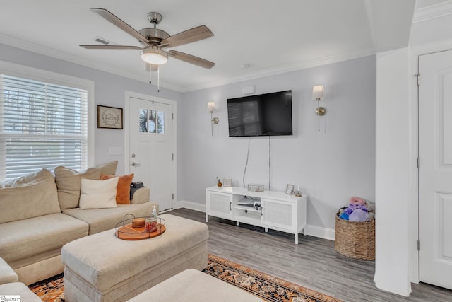 living room with hardwood / wood-style flooring, ornamental molding, and ceiling fan