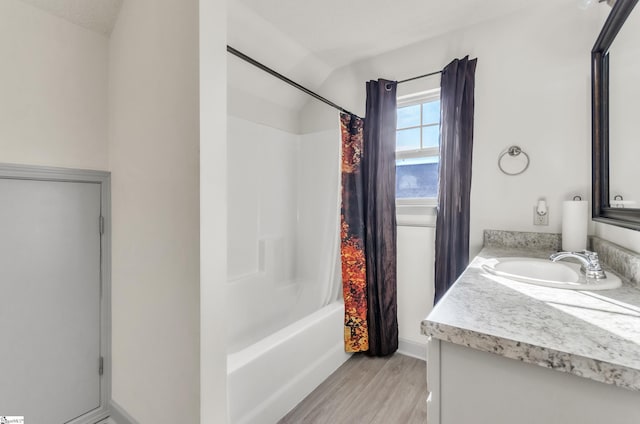 bathroom featuring vanity, wood-type flooring, and shower / tub combo