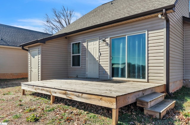 rear view of property featuring a deck