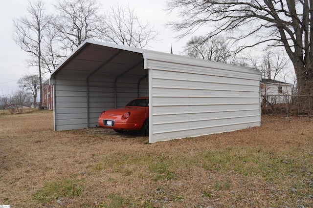 view of outdoor structure with a carport and a yard