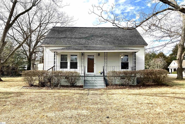 bungalow-style house featuring a front lawn and covered porch