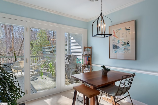 dining space with crown molding and french doors