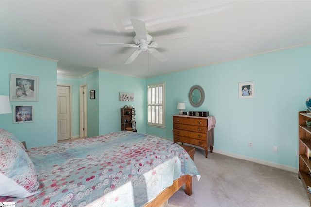 bedroom featuring ornamental molding, light colored carpet, and ceiling fan