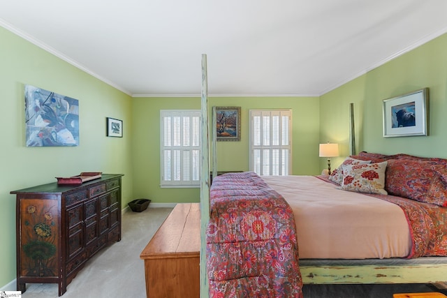 bedroom with ornamental molding and light colored carpet