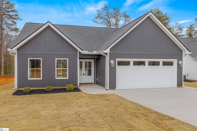 view of front of home with a garage and a front lawn