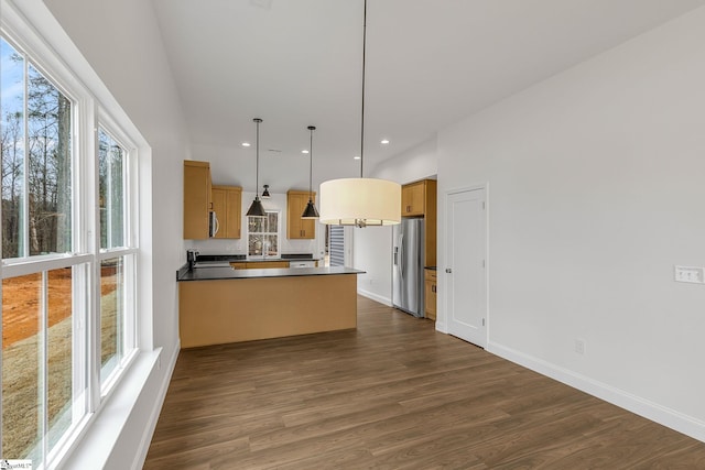 kitchen with dark hardwood / wood-style flooring, decorative light fixtures, kitchen peninsula, and stainless steel refrigerator with ice dispenser