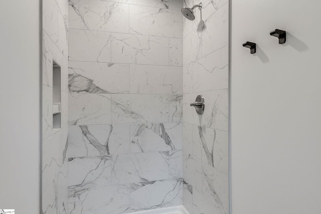 interior details with a tile shower