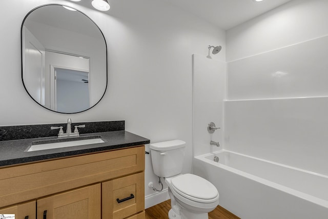 full bathroom with vanity, hardwood / wood-style flooring, bathtub / shower combination, and toilet