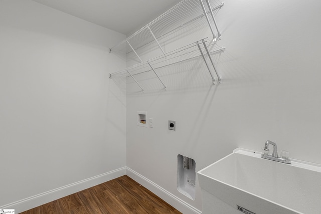 laundry area with dark hardwood / wood-style flooring, sink, hookup for a washing machine, and hookup for an electric dryer