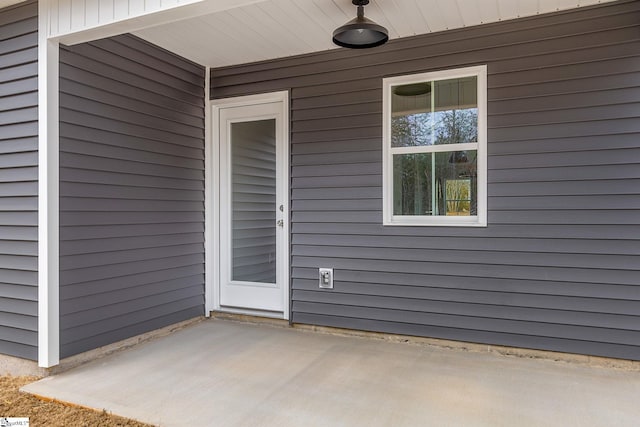 doorway to property with a patio area