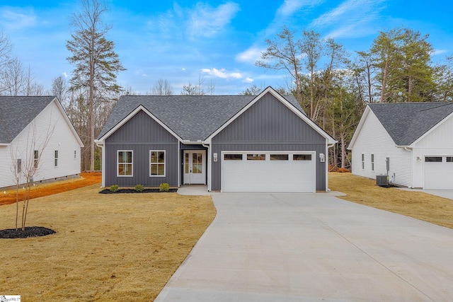 modern inspired farmhouse with a garage, central AC, and a front yard