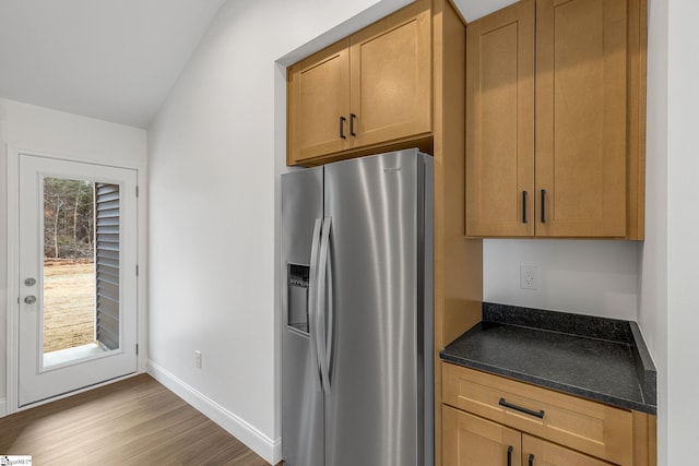 kitchen with wood-type flooring and stainless steel fridge