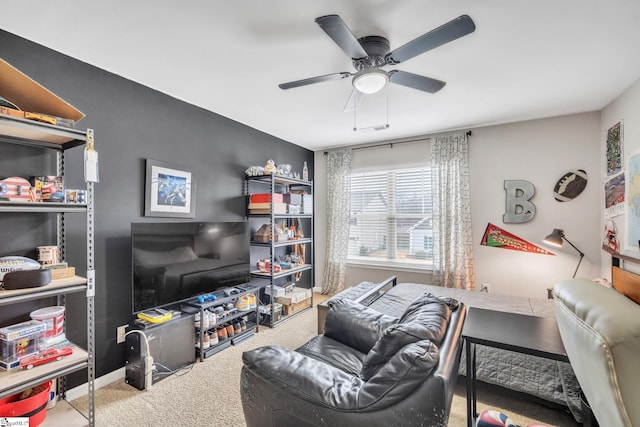 living room with ceiling fan and carpet