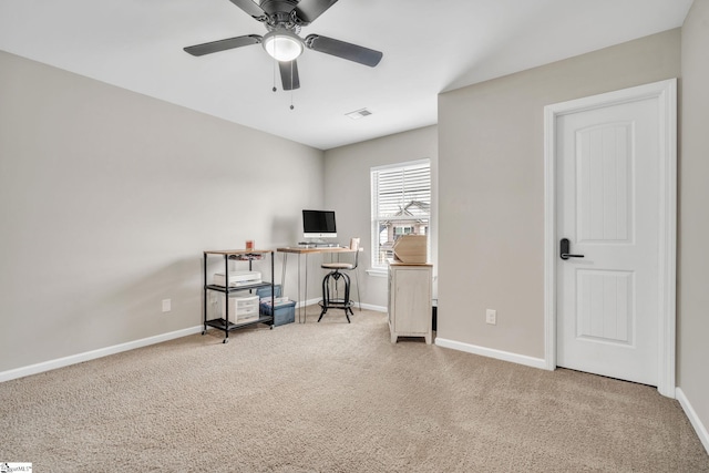 carpeted office space featuring ceiling fan