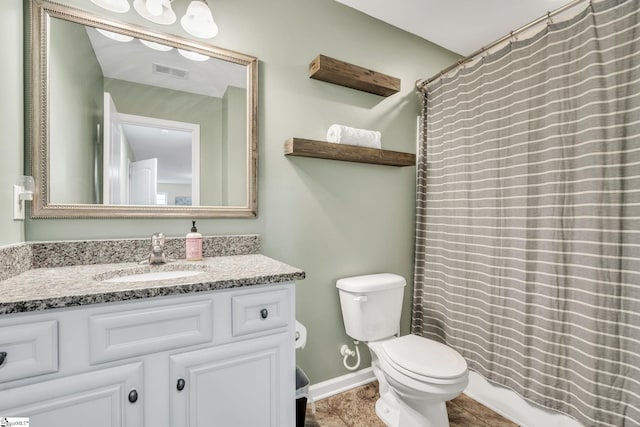 bathroom with vanity, walk in shower, and toilet