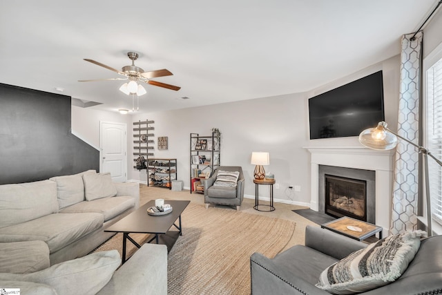 carpeted living room featuring ceiling fan