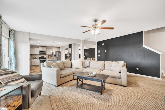 living room with ceiling fan and light carpet