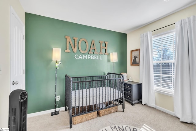 carpeted bedroom with a nursery area